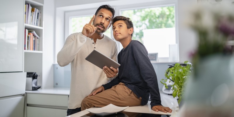 father and son using tablet
