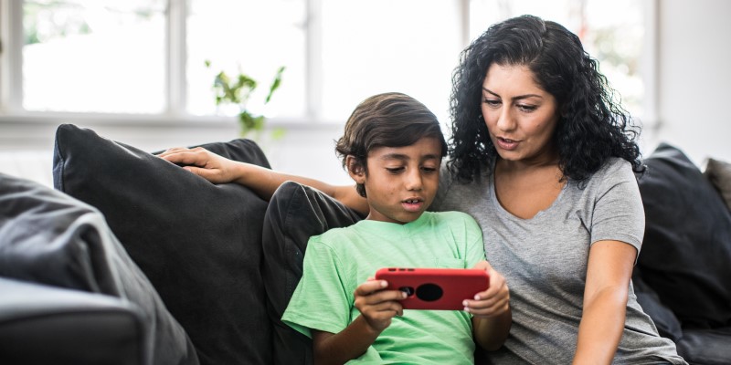 mother and son sitting on couch
