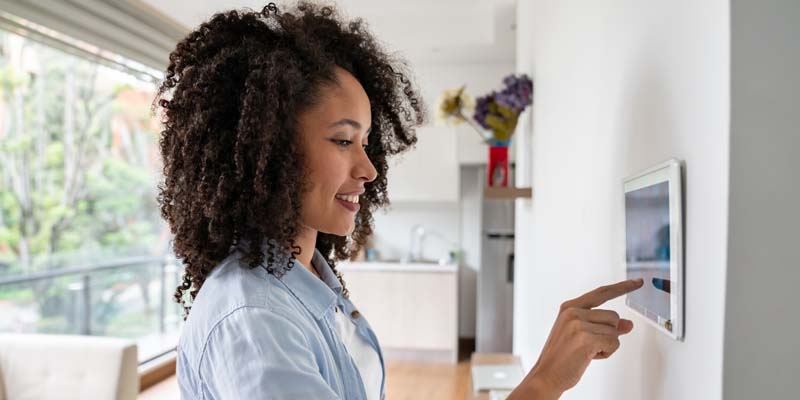 Woman touching smart home device